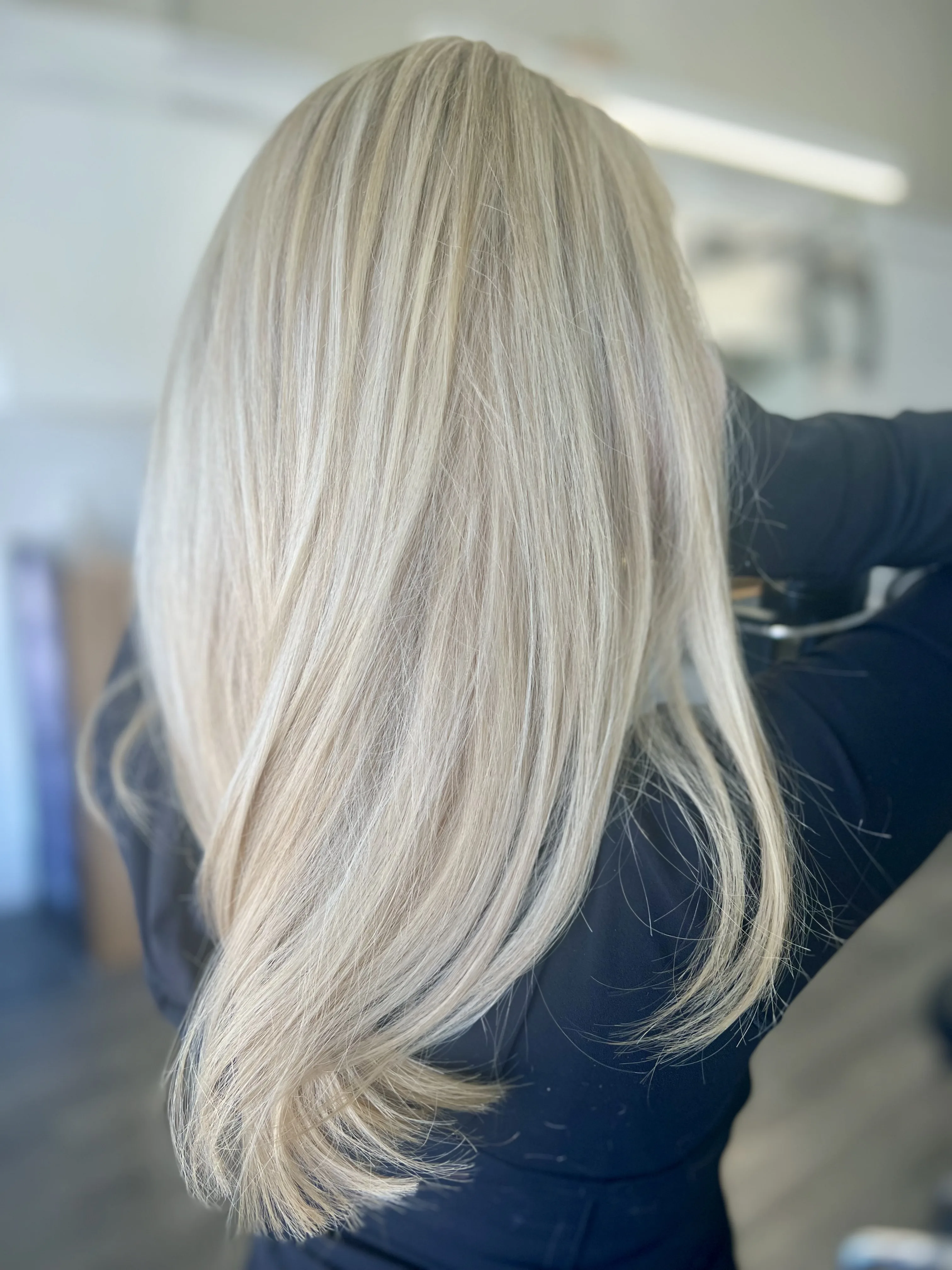 Icy blonde straight glossy blow-dry, back view
