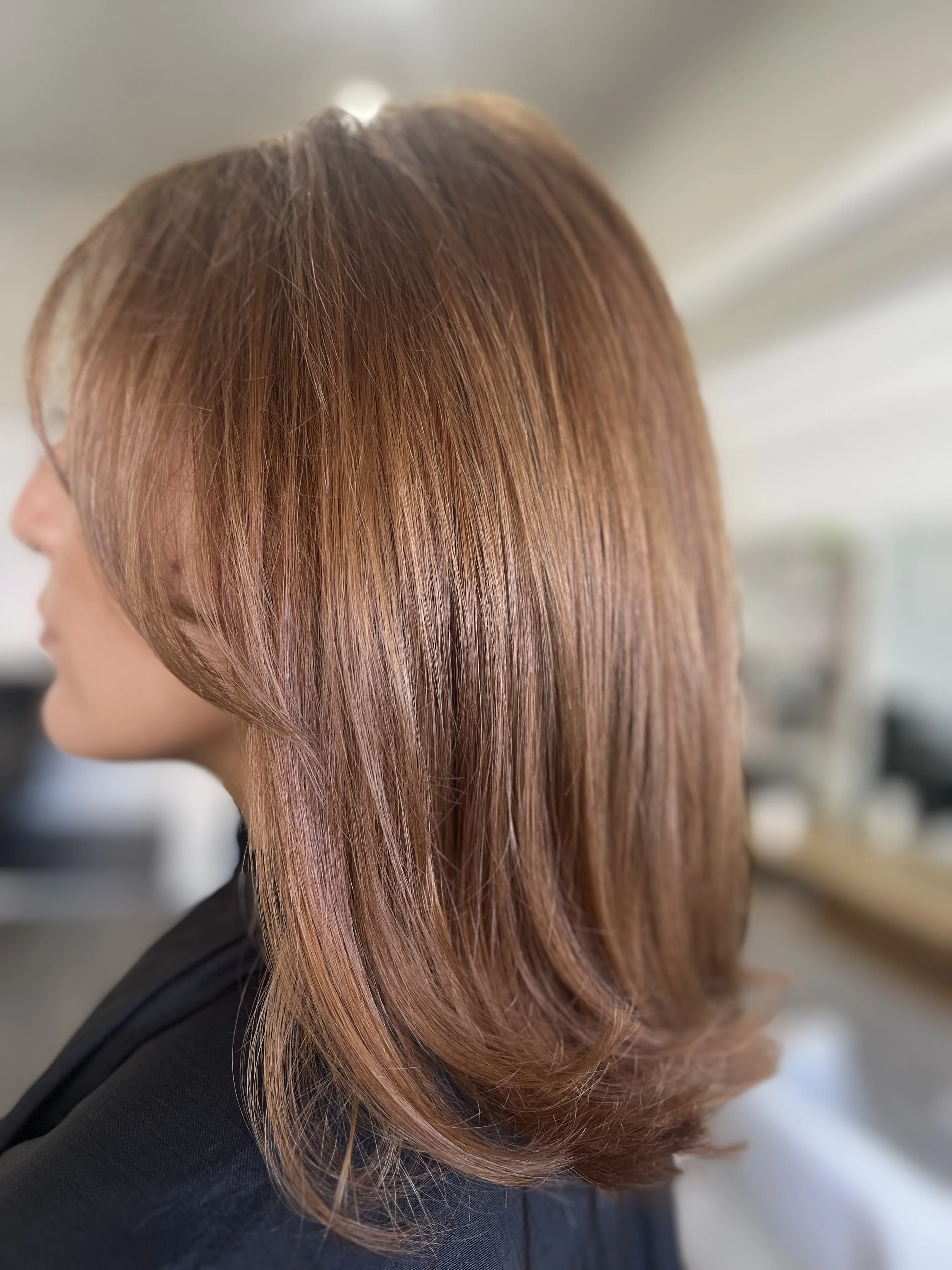 Warm auburn layered blow-wave, side view
