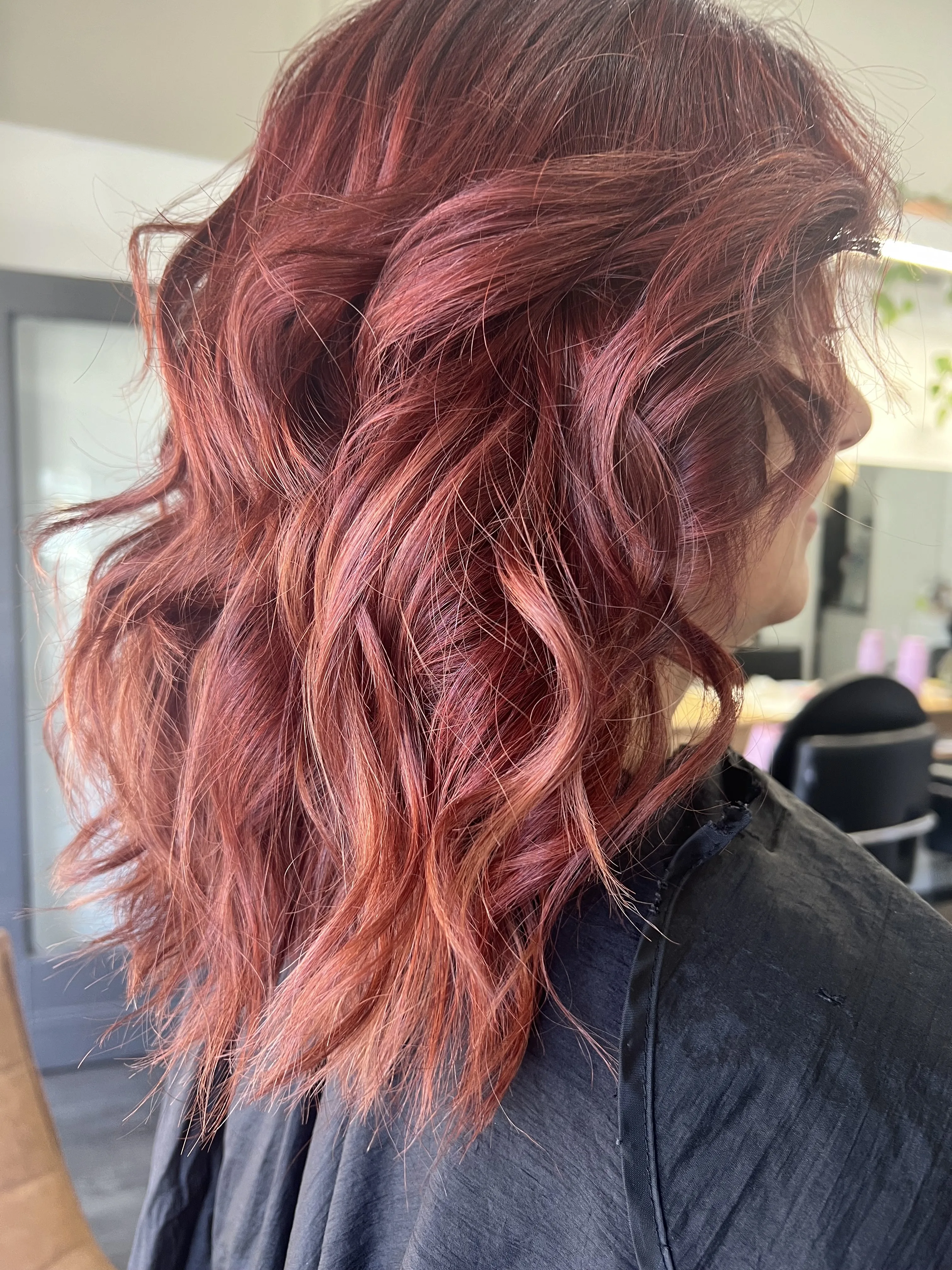 Burgundy-copper tousled waves, side view